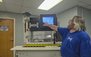 Pillar Service team member performing calibration on an OTF-1 machine.